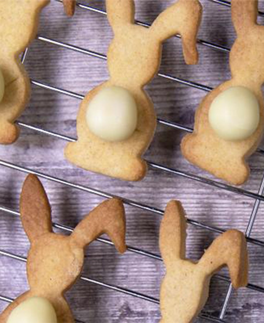 Shortbread bunny biscuits with Milkybar white chocolate mini egg tails cooling on a wire rack