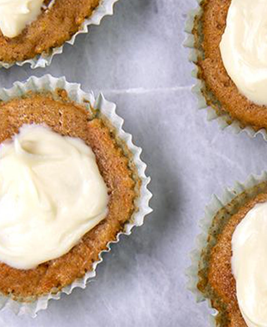 Close up of carrot cupcake with white cream cheese buttercream icing