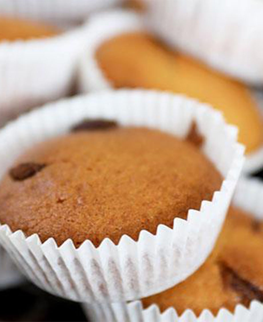Half-size muffins made with milkybar and chocolate chips in a white cupcake case.