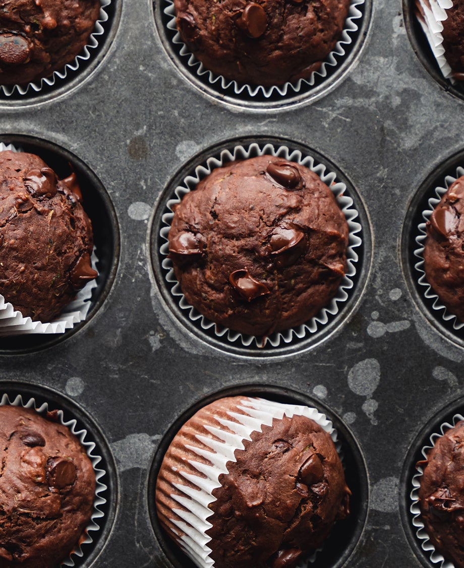 Dark chocolate muffins with chocolate chips in a baking tray
