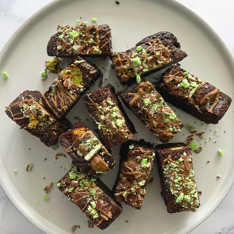 Dark chocolate mint brownies on a white plate and white marble worktop, made with Aero Peppermint