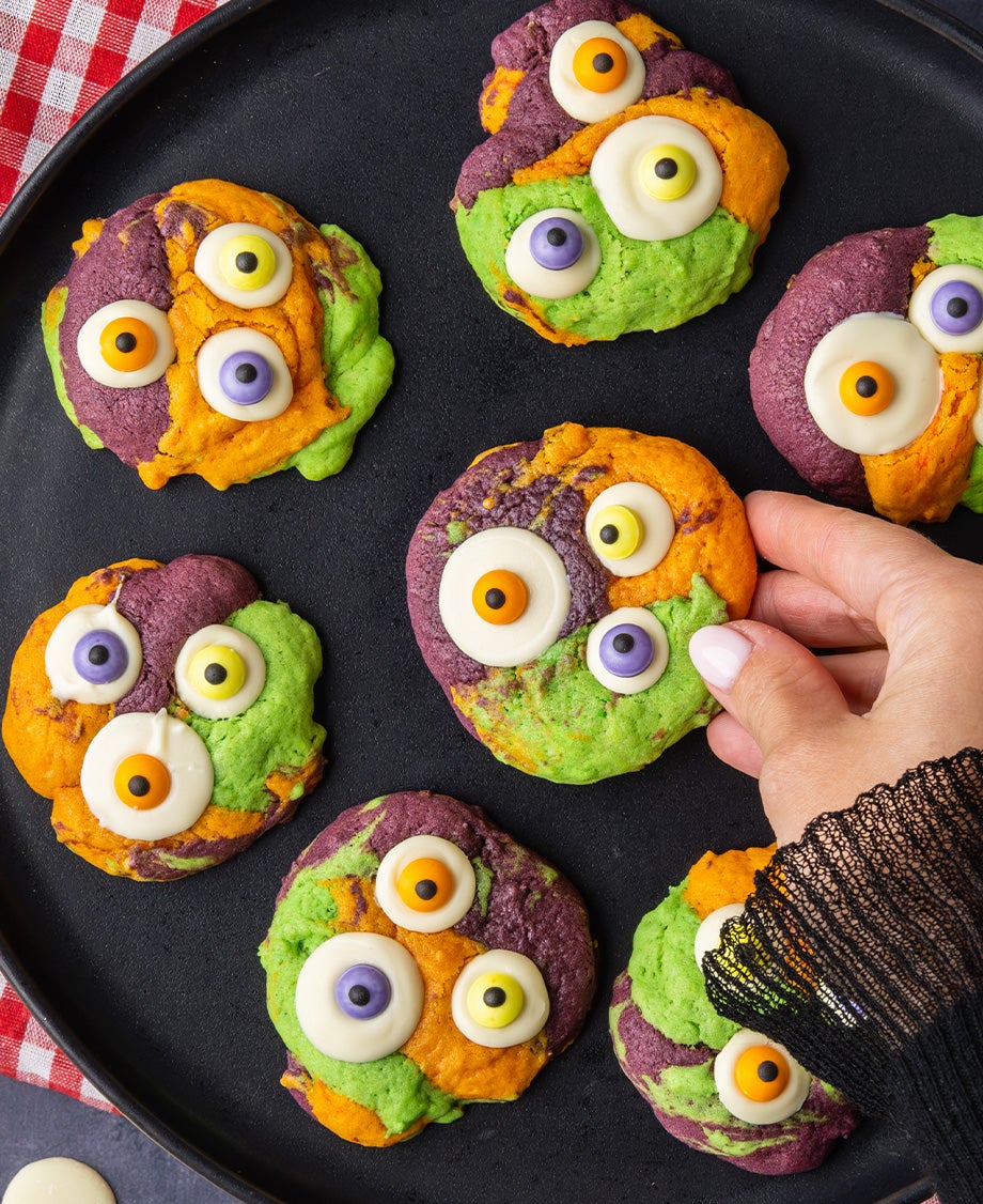  Orange, Green and Purple monster cookies with three Milkybar white chocolate googly eyes with purple, yellow and orange Smar