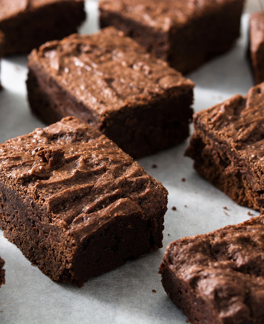 Close-up of chocolate brownie squares on white baking paper