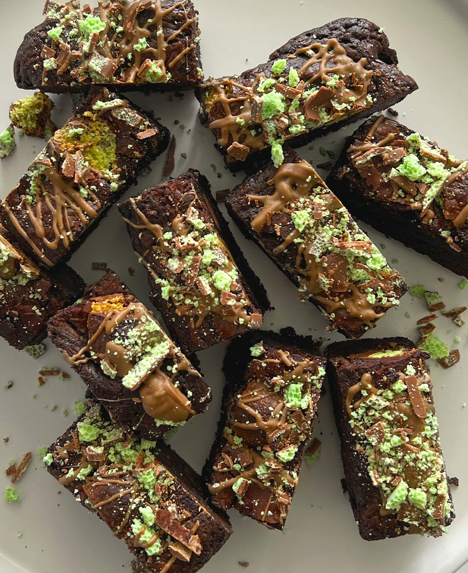 Dark chocolate mint brownies on a white plate and white marble worktop, made with Aero Peppermint