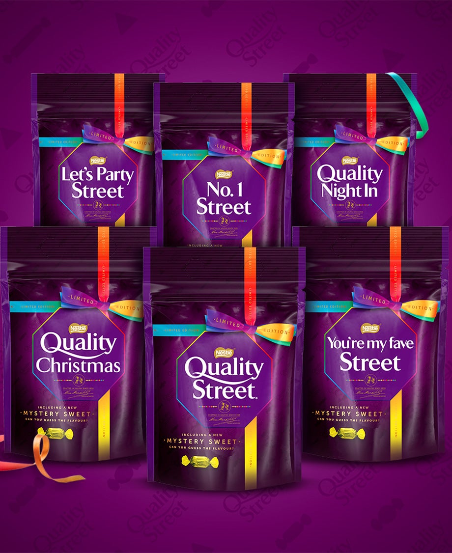 Arrangement of six Quality Street pouches against a branded purple background, each with a different greeting on