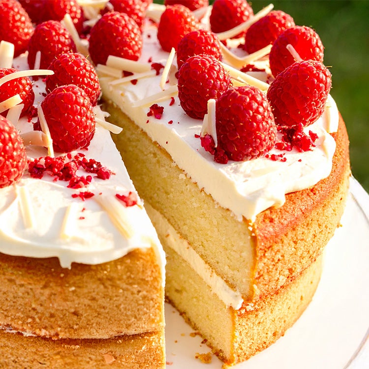 Vanilla sponge cake with a Milkybar white chocolate buttercream filling and topping, decorated with strawberries