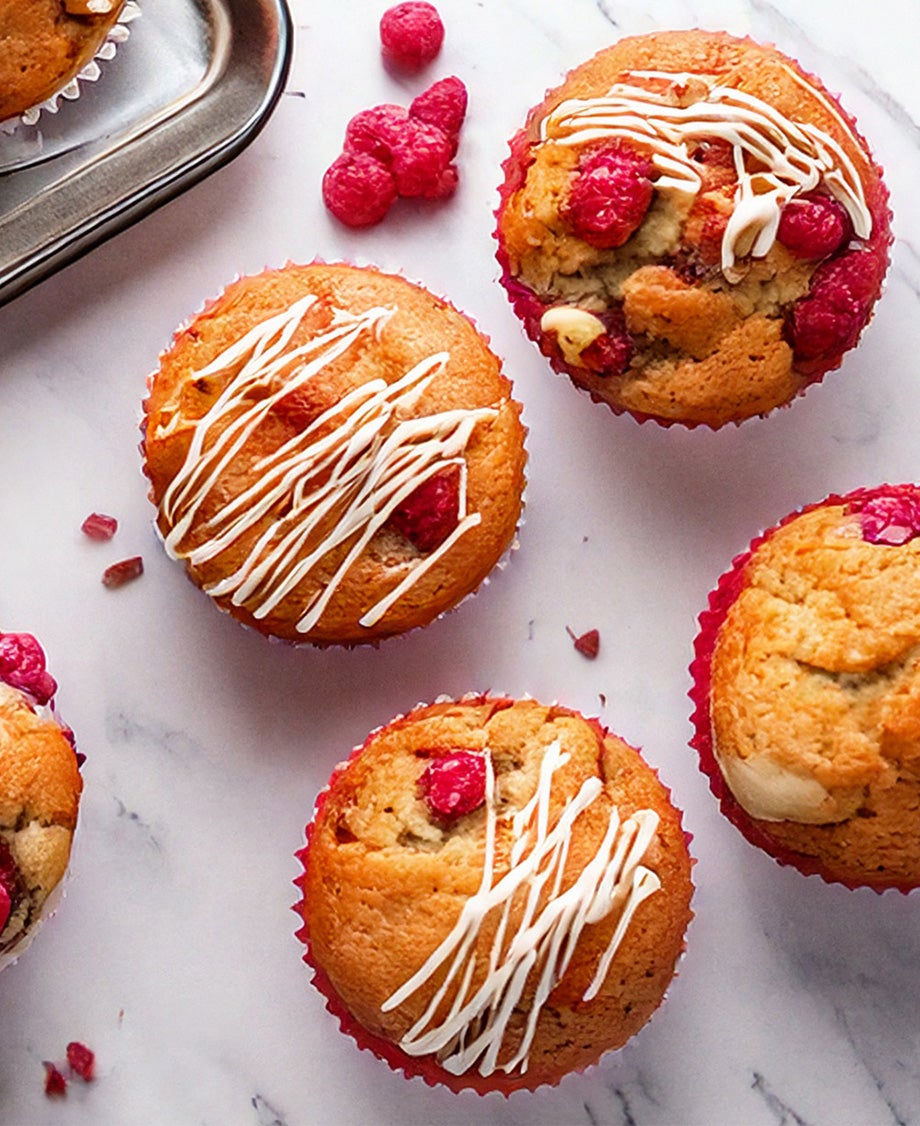 Golden raspberry and white chocolate muffins drizzled with white chocolate