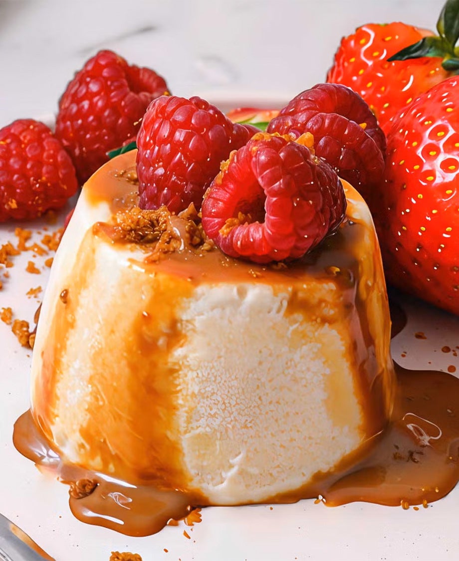 Upside-down Milkybar Mousse drizzled with caramel sauce with fresh raspberries and strawberries alongside 