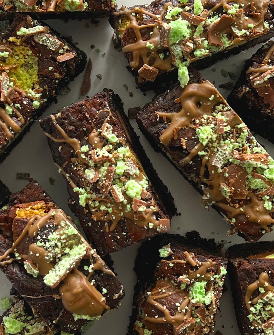 A plate of chocolate brownies topped with colorful sprinkles, showcasing their rich texture