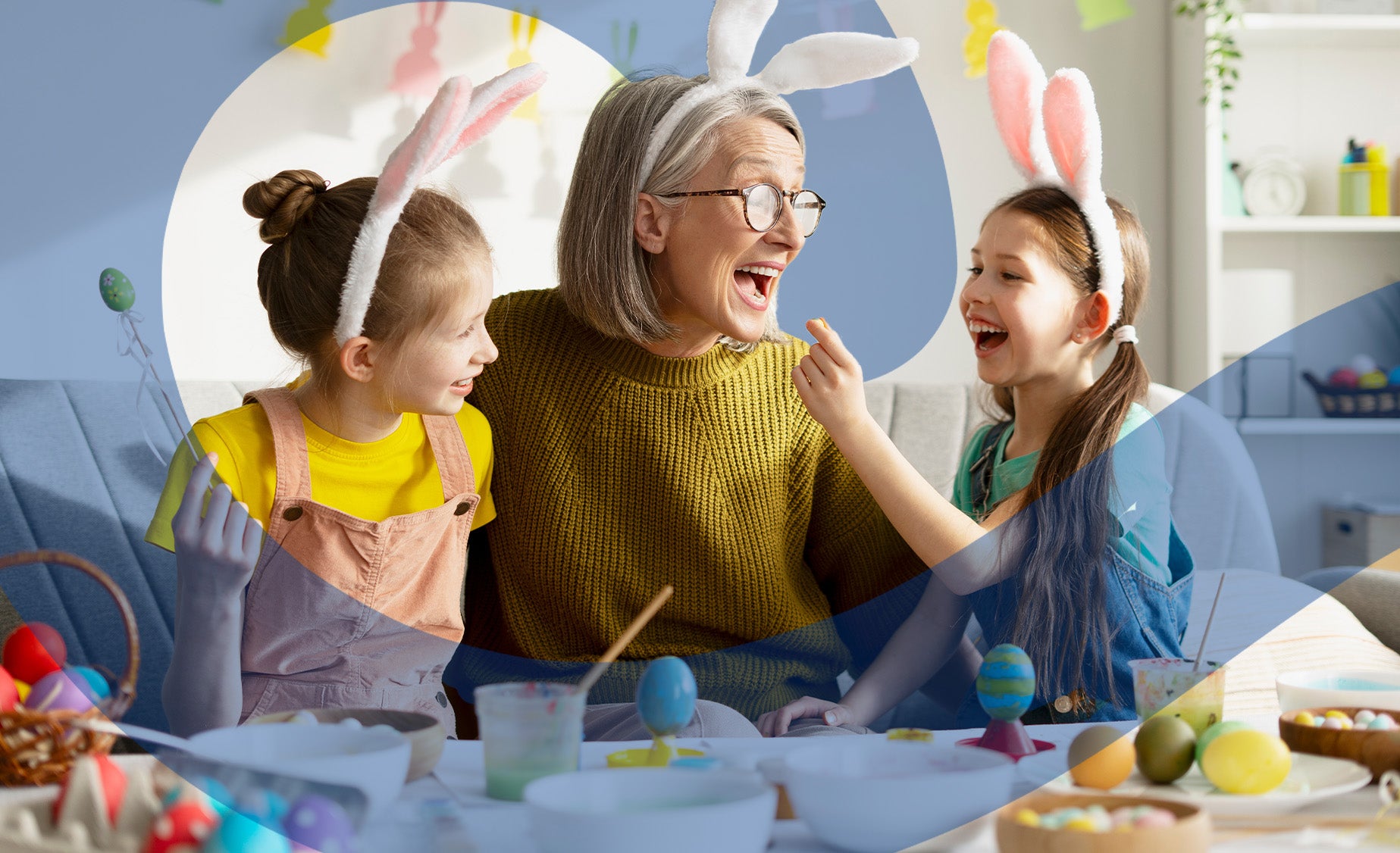 A grandmother having fun crafting eggs with her family