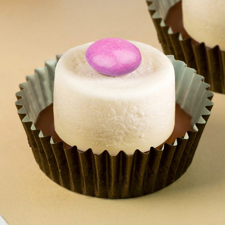 Marshmallow Top Hat consisting of a marshmallow with a melted chocolate base topped with a single Smartie, in a cupcake case
