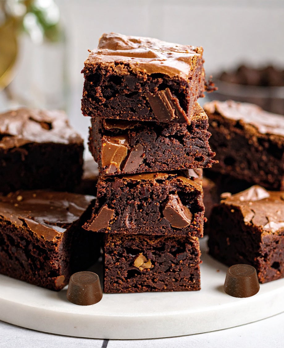 Stack of rich, fudgy Rolo salted caramel brownies with gooey caramel centres and chocolate chunks