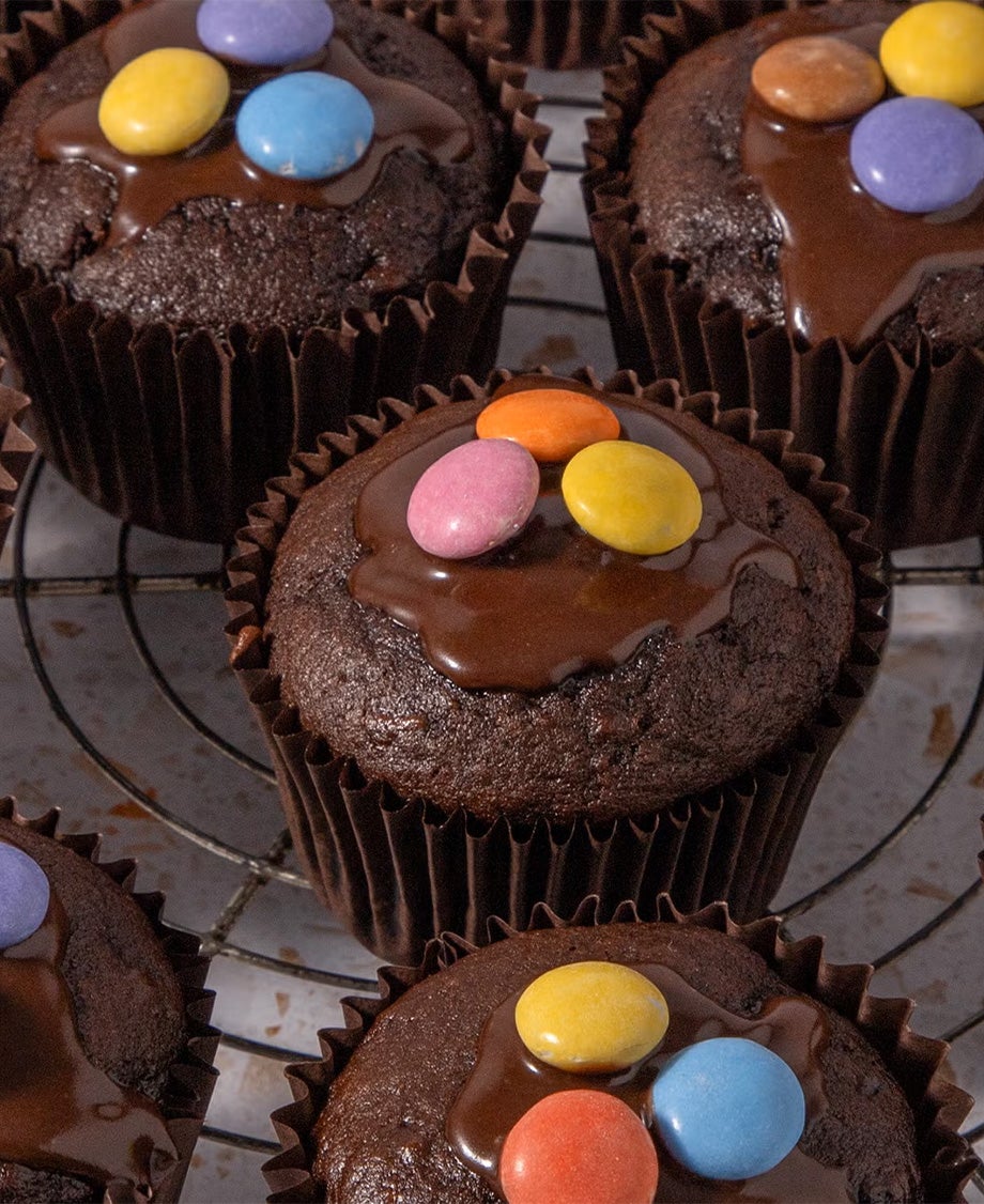 muffins with each 3 smarties on top, on top of a tray