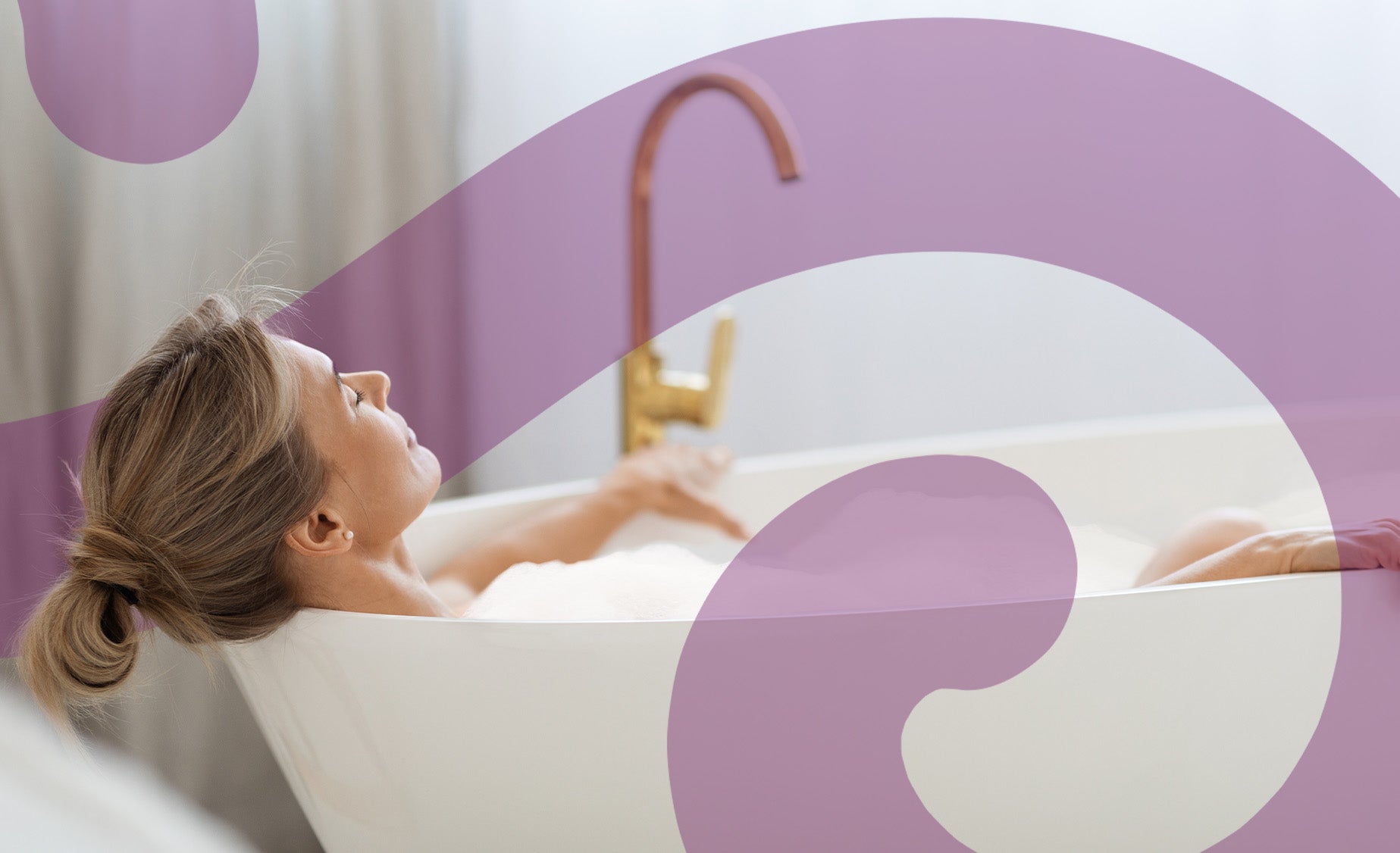 A woman relaxing in a foamy bath 