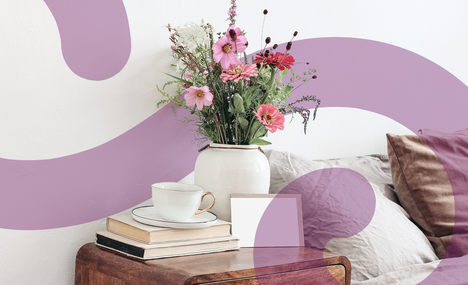 A bedside table with a beautiful bunch of flowers on it