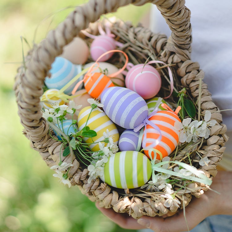  A small rattan basket filled with colourful decorated Easter eggs 