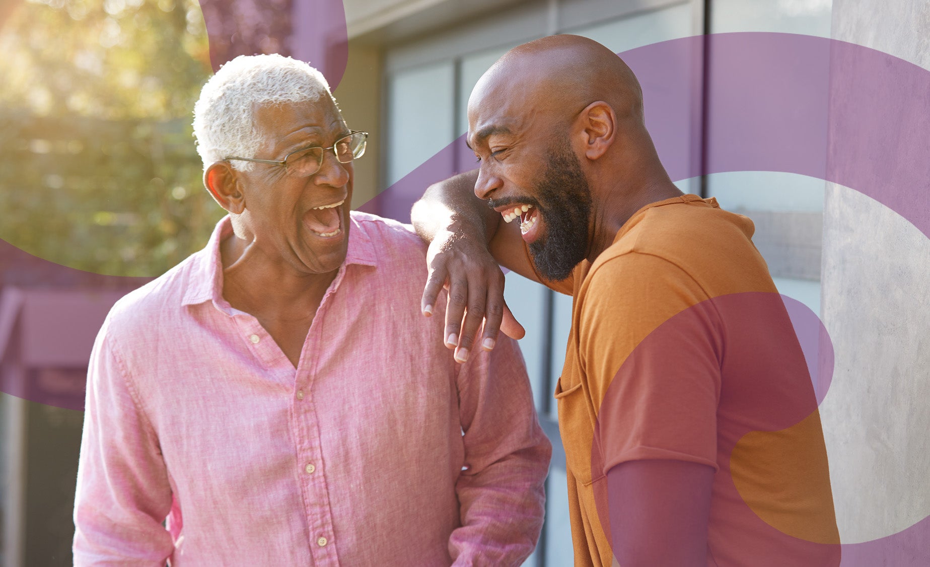A man laughs with his elderly father 