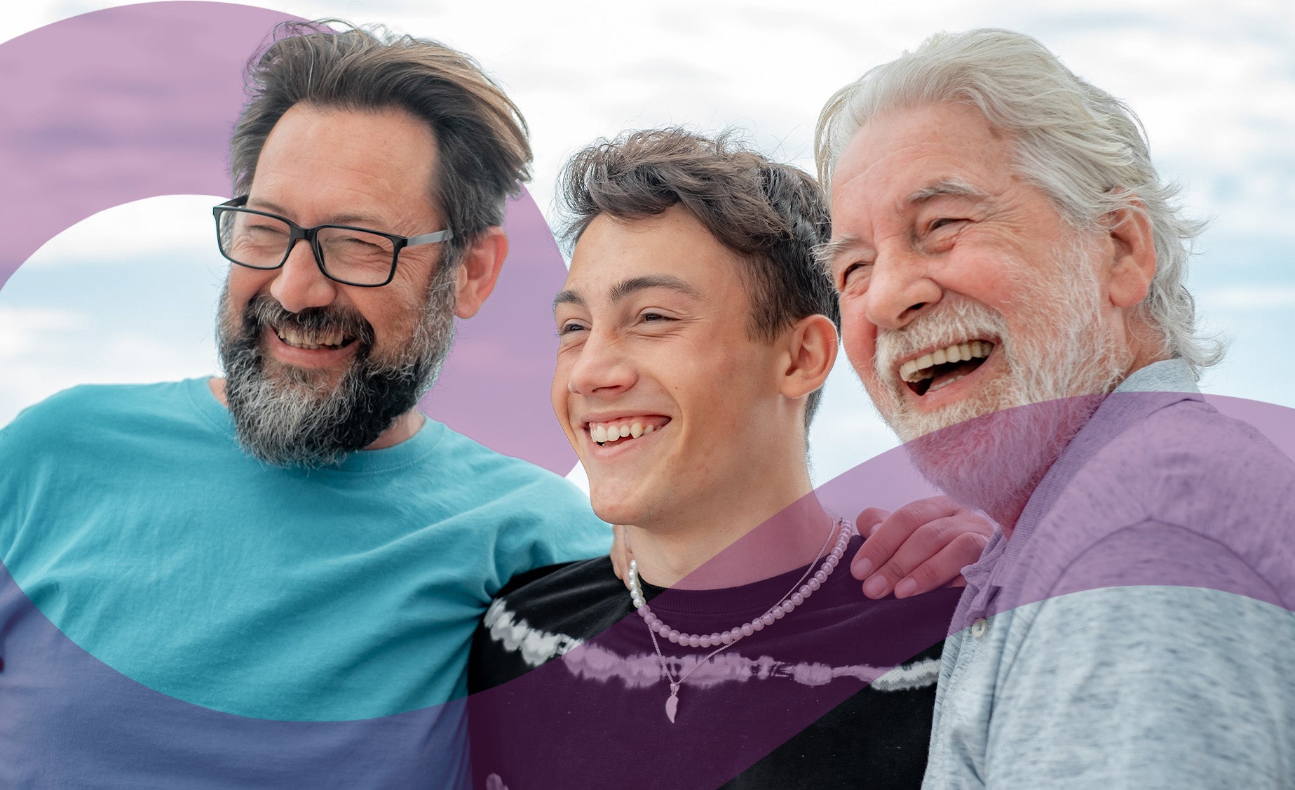 A boy with his father and grandfather, smiling. 