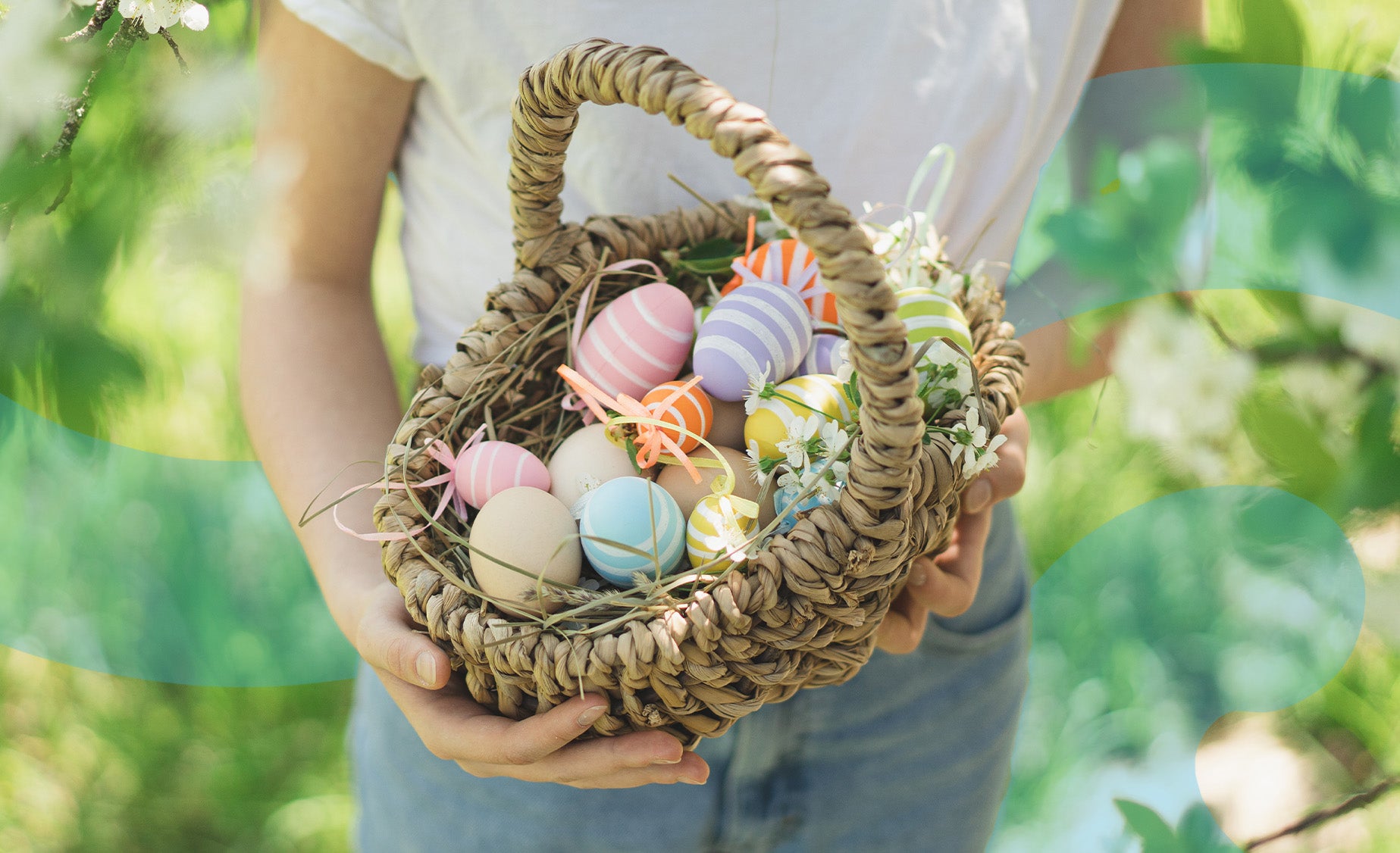 A woman holding a basket of pastel-coloured decorative eggs 