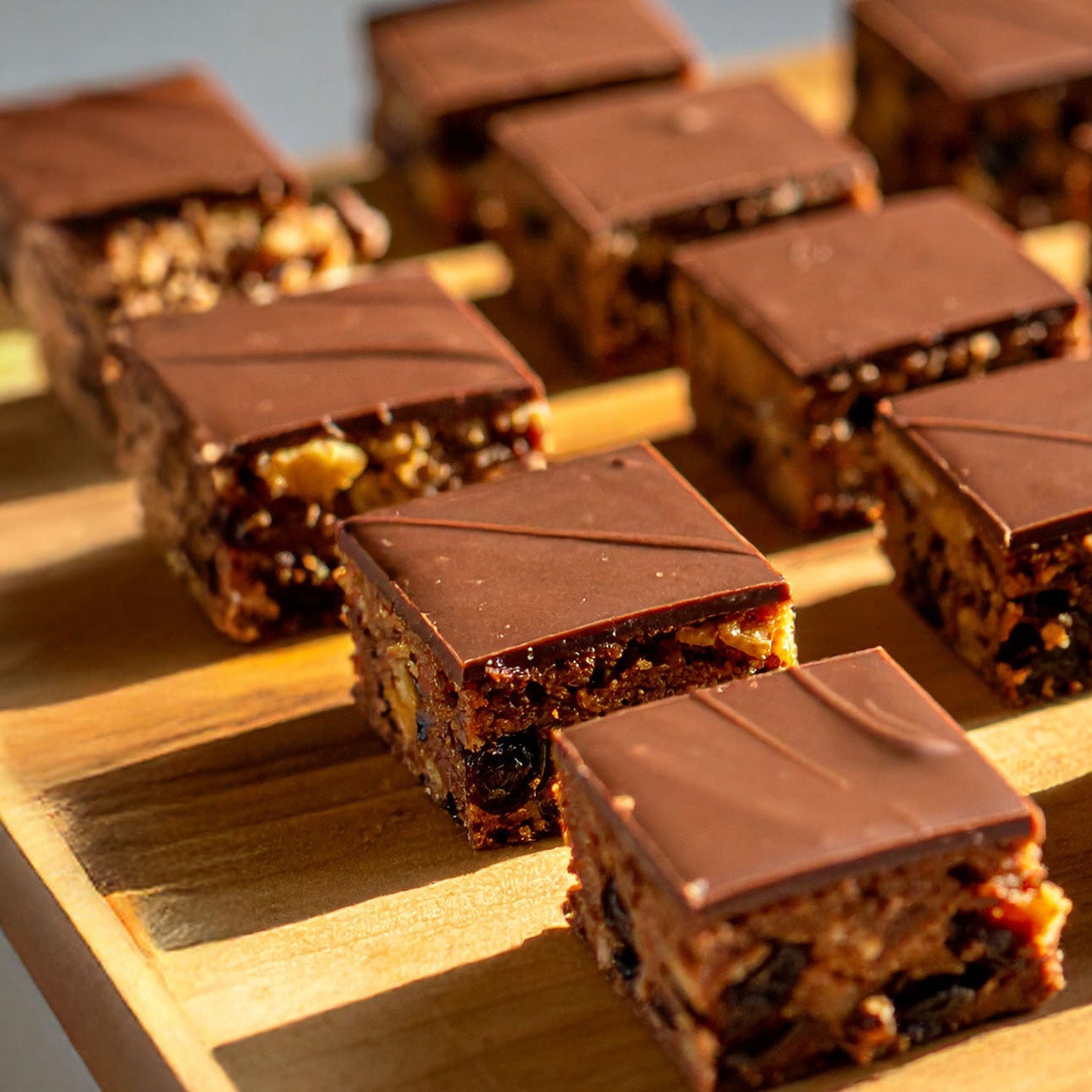 Squares of Chocolate Tiffin on a wood board